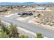 An aerial view of a well-maintained home with desert landscaping, an attached two-car garage, and mountain views at 3050 Oakridge Ave, Pahrump, NV 89048