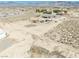An aerial view of desert land, neighborhood homes, mountain views, and the property with horse property at 3050 Oakridge Ave, Pahrump, NV 89048