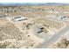 Drone shot of a home on large lot with desert landscaping, featuring a pool and outbuildings, set against mountain views at 3050 Oakridge Ave, Pahrump, NV 89048