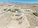 An aerial view of desert land, neighborhood homes, and mountain views in the background at 3050 Oakridge Ave, Pahrump, NV 89048