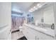 Bathroom featuring double sinks, granite counters, and a wood-look shower curtain at 3050 Oakridge Ave, Pahrump, NV 89048