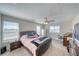Comfortable bedroom with carpeted floor, ceiling fan, and views of the landscape at 3050 Oakridge Ave, Pahrump, NV 89048