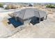 A bird's eye view of a single-story home with a gray tiled roof, desert landscaping, and a fenced yard at 3050 Oakridge Ave, Pahrump, NV 89048