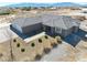 A tan single-story home with a gray tiled roof, desert landscaping, and an attached two-car garage at 3050 Oakridge Ave, Pahrump, NV 89048