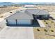 Stunning home featuring a three-car garage, tile roof, and desert landscaping at 3050 Oakridge Ave, Pahrump, NV 89048