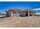 Angled view of rear exterior of desert home featuring a covered patio at 3050 Oakridge Ave, Pahrump, NV 89048
