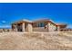 Rear exterior of desert home featuring covered patio at 3050 Oakridge Ave, Pahrump, NV 89048