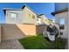 Charming backyard with artificial turf, gravel, and a stylish hanging chair for relaxing outdoors at 3354 Via Strada St, Henderson, NV 89044