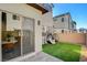 Backyard featuring artificial turf, brick paver patio, privacy wall, and hanging egg chairs at 3354 Via Strada St, Henderson, NV 89044