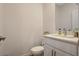 Modern half-bathroom with white vanity, elegant fixtures, and contemporary design at 3354 Via Strada St, Henderson, NV 89044