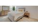 Cozy bedroom with neutral tones, featuring a dresser, stylish headboard, and a minimalist nightstand at 3354 Via Strada St, Henderson, NV 89044