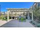 Common area featuring an outdoor kitchen, tables, chairs and pergola at 3354 Via Strada St, Henderson, NV 89044