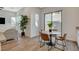 Bright dining area featuring a marble table set, stylish seating and sliding glass doors at 3354 Via Strada St, Henderson, NV 89044