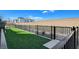 Community dog run featuring artificial turf and black metal fencing, enhancing outdoor living at 3354 Via Strada St, Henderson, NV 89044