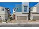 Modern home exterior showcasing a two-car garage, red door, and contemporary architectural details at 3354 Via Strada St, Henderson, NV 89044