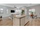 Stylish kitchen with a large island, stainless steel appliances, and open access to the dining and living areas at 3354 Via Strada St, Henderson, NV 89044