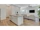 Open-concept with a kitchen island and seating, which flows into the living room at 3354 Via Strada St, Henderson, NV 89044