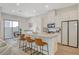 Modern kitchen with stainless steel appliances, a kitchen island with seating, and plenty of natural light at 3354 Via Strada St, Henderson, NV 89044