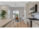 Bright kitchen featuring stainless steel appliances, quartz countertops, and wood-look flooring at 3354 Via Strada St, Henderson, NV 89044
