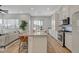 Open concept kitchen featuring a large island with bar seating and modern stainless steel appliances at 3354 Via Strada St, Henderson, NV 89044