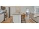 Open concept featuring a kitchen with a gray island with room for seating at 3354 Via Strada St, Henderson, NV 89044