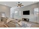 Bright living room featuring a comfortable sectional sofa, a large flat-screen TV, and contemporary decor at 3354 Via Strada St, Henderson, NV 89044