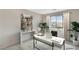 Modern staged office featuring a white desk, comfortable chair, neutral colors, and plenty of natural light at 3354 Via Strada St, Henderson, NV 89044