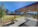 Community park with a pergola, seating, and a grassy area at 3354 Via Strada St, Henderson, NV 89044