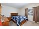 Bedroom featuring a queen-sized bed with wood frame, a dresser and soft natural light from the window at 3660 Renovah St # 201, Las Vegas, NV 89129