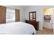 Bright bedroom with white linens, wood dresser, and large window, creating a relaxing and inviting atmosphere at 3660 Renovah St # 201, Las Vegas, NV 89129