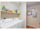 Practical laundry room featuring a washer, dryer, and storage shelf at 3660 Renovah St # 201, Las Vegas, NV 89129