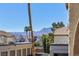 Townhome view showcasing desert landscape with palm trees, mountains, and blue skies at 3660 Renovah St # 201, Las Vegas, NV 89129