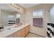 Bathroom featuring double sinks, framed mirror, shower, and bathtub at 3747 Gulliver St, Las Vegas, NV 89115