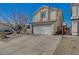 View of a charming two-story home featuring a two-car garage, tile roof, and spacious driveway at 3747 Gulliver St, Las Vegas, NV 89115