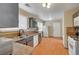 Traditional kitchen with granite countertops, wood-look floors, and white appliances and plenty of natural light at 3747 Gulliver St, Las Vegas, NV 89115