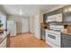 A functional kitchen space with gas range, wood-look flooring, and ample storage solutions at 3747 Gulliver St, Las Vegas, NV 89115