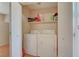 Closet with white washer and dryer, and a shelf with laundry products at 3747 Gulliver St, Las Vegas, NV 89115