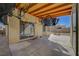 Covered patio with ceiling beams, concrete floor and multiple bicycles hung from the ceiling at 3747 Gulliver St, Las Vegas, NV 89115
