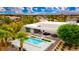 An aerial view shows the modern house, a pool, patio with outdoor dining, and desert landscaping at 4135 N Durango Dr, Las Vegas, NV 89129