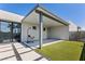 Modern backyard with covered patio, artificial grass, and minimalist landscaping at 4135 N Durango Dr, Las Vegas, NV 89129