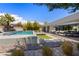 This backyard features a sleek pool, lounge area, outdoor dining, and desert-friendly landscaping at 4135 N Durango Dr, Las Vegas, NV 89129