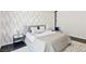 Modern bedroom with stylish bed, nightstands, and patterned wallpaper and a plush rug at 4135 N Durango Dr, Las Vegas, NV 89129