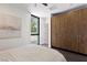 Bright bedroom featuring wood-look wardrobe, large window, light colored walls and dark wood floors at 4135 N Durango Dr, Las Vegas, NV 89129