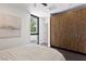 Bright bedroom featuring wood-look wardrobe, large window, light colored walls and dark wood floors at 4135 N Durango Dr, Las Vegas, NV 89129