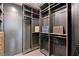Spacious walk-in closet with custom shelving and dark wood finish, providing ample storage space at 4135 N Durango Dr, Las Vegas, NV 89129