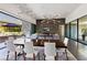Open-concept dining room with modern lighting and seamless indoor-outdoor flow to patio at 4135 N Durango Dr, Las Vegas, NV 89129