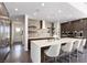 Modern kitchen features an island, stainless steel appliances, and sleek dark cabinetry at 4135 N Durango Dr, Las Vegas, NV 89129