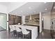 Modern kitchen with large center island, recessed lighting, and dark wood cabinets at 4135 N Durango Dr, Las Vegas, NV 89129