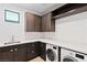 Well-equipped laundry room with modern washer, dryer, cabinets, and countertop at 4135 N Durango Dr, Las Vegas, NV 89129
