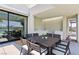 Covered outdoor dining area with a modern table, chairs, and an outdoor kitchen with a sink at 4135 N Durango Dr, Las Vegas, NV 89129
